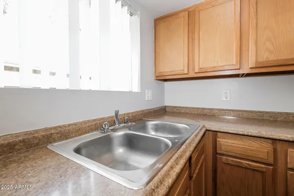 a kitchen with white cabinets a sink dishwasher and a stove top oven