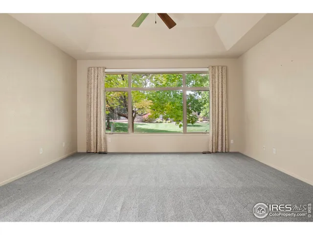 a living room with furniture a large window and a fireplace