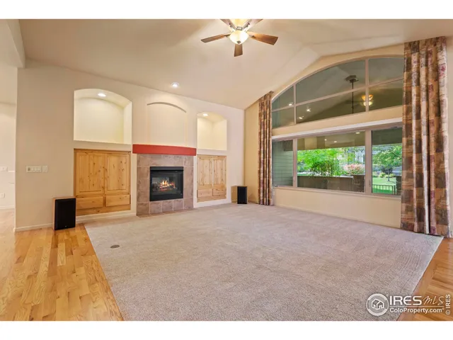 a kitchen with stainless steel appliances granite countertop a stove a sink and white cabinets with wooden floor