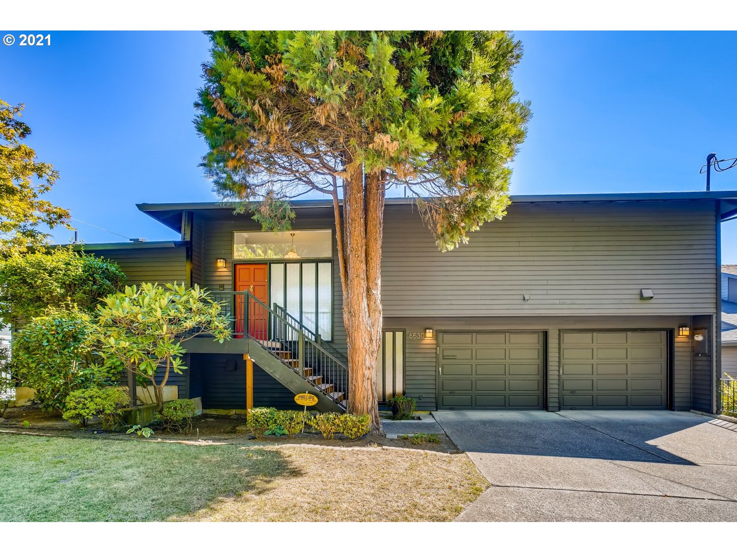 6530 Southwest View Point Terrace Portland, OR 97239 - Photo 1 of 32 a front view of a house with a yard garage and outdoor seating
