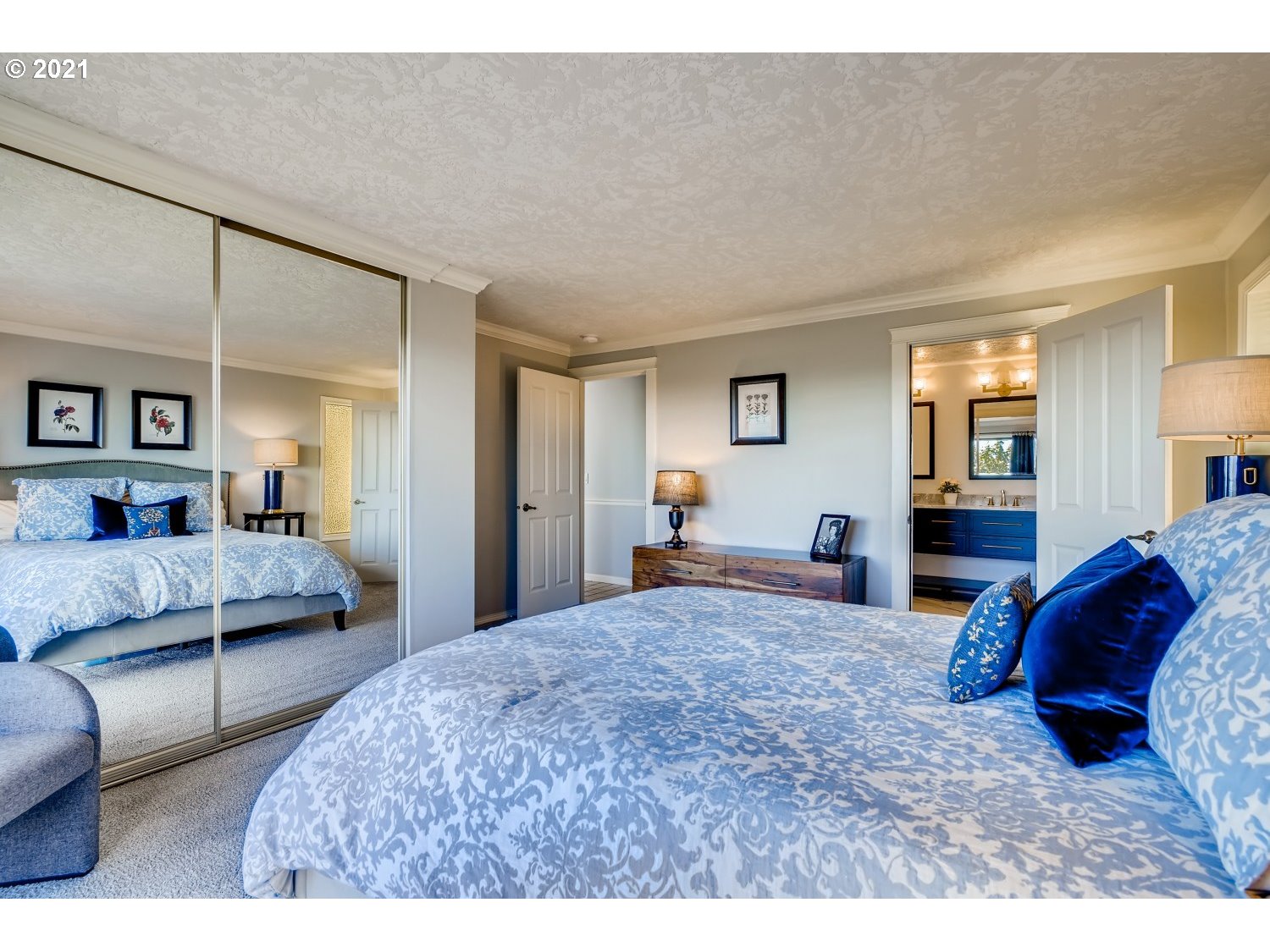 6530 Southwest View Point Terrace Portland, OR 97239 - Photo 20 of 32 a bedroom with a bed and a large mirror