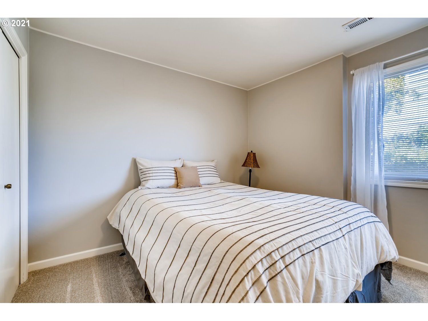 6530 Southwest View Point Terrace Portland, OR 97239 - Photo 27 of 32 a bedroom with a bed and a window