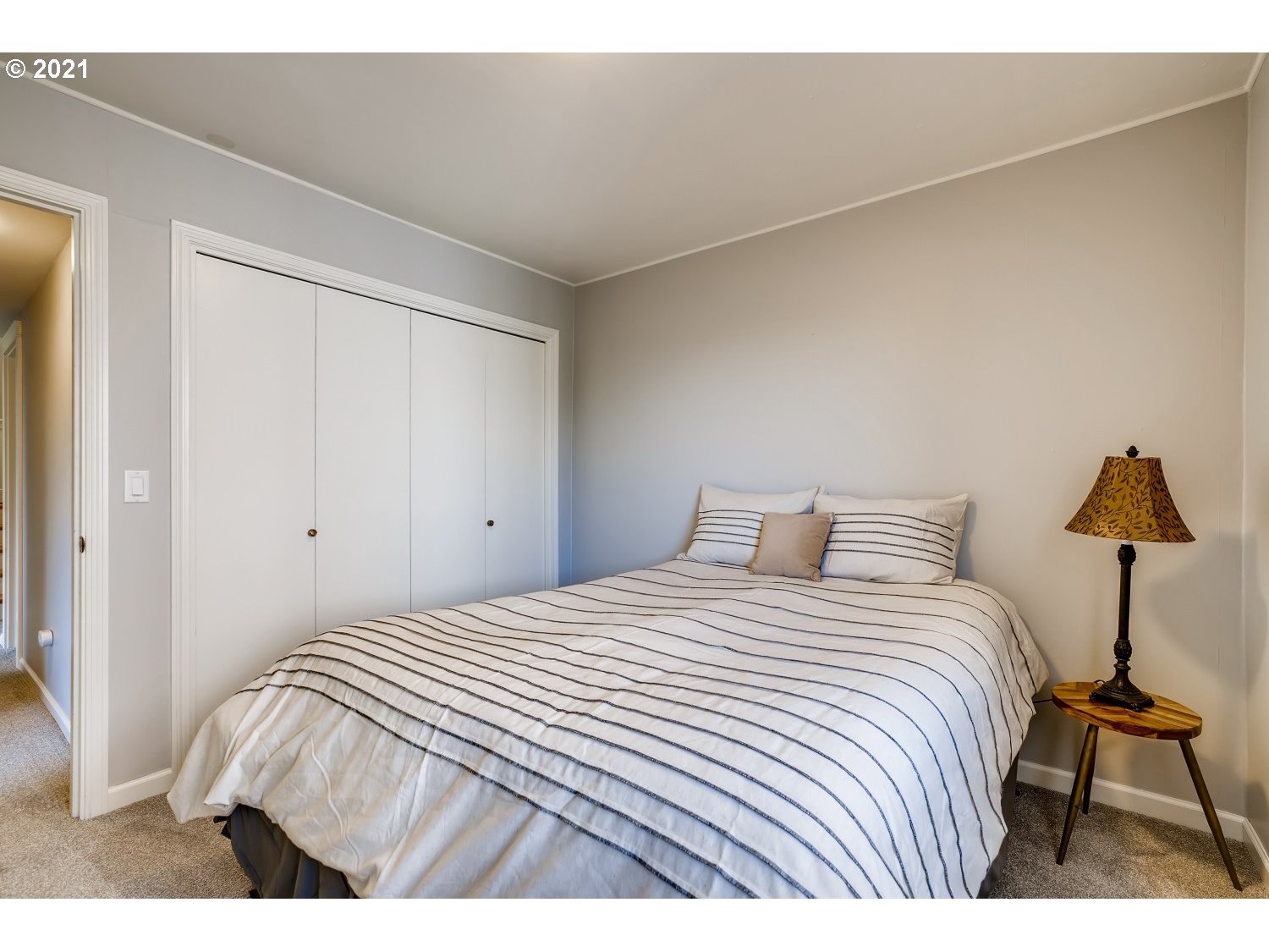 6530 Southwest View Point Terrace Portland, OR 97239 - Photo 28 of 32 a bedroom with a bed and a lamp