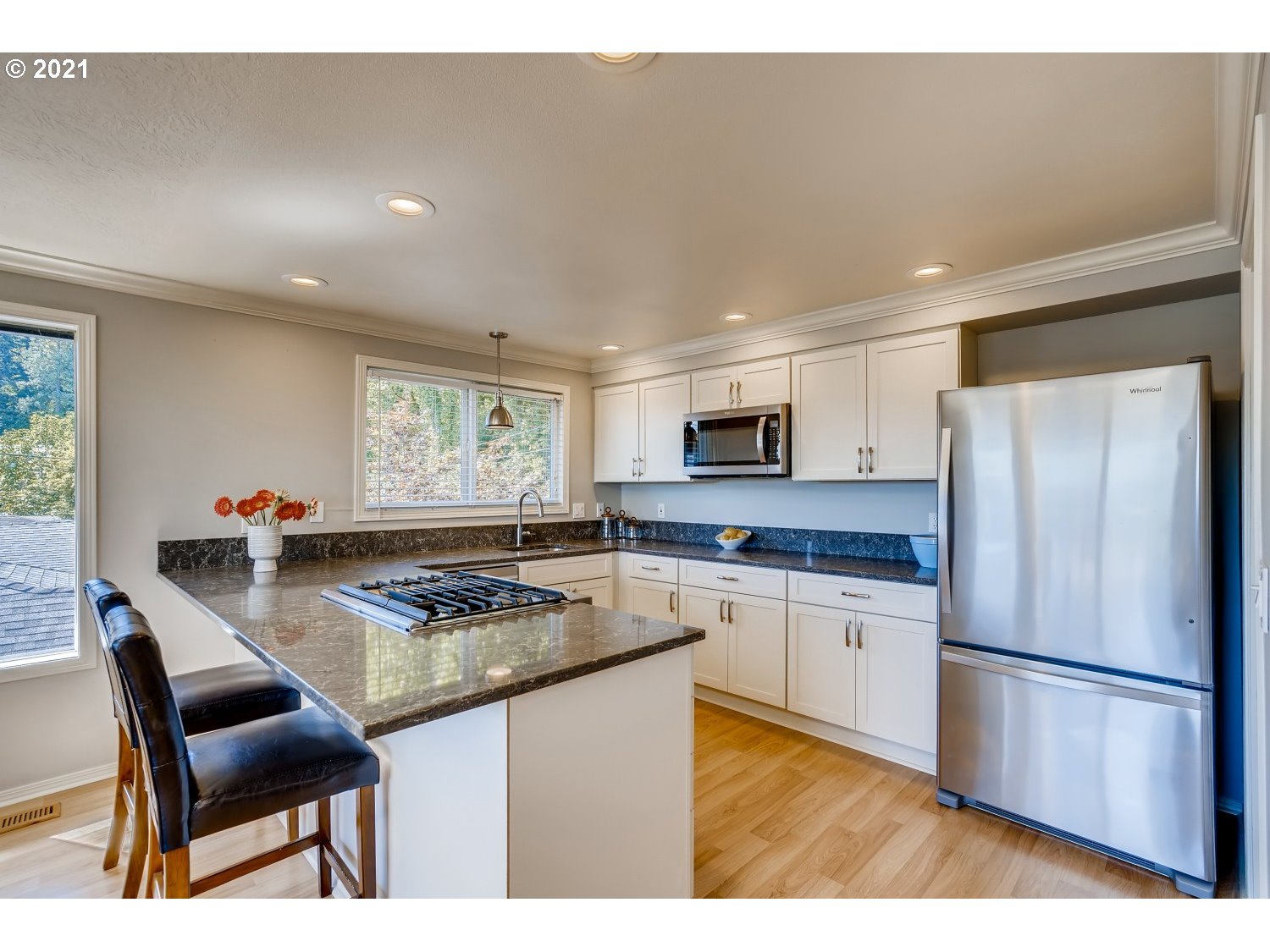 6530 Southwest View Point Terrace Portland, OR 97239 - Photo 8 of 32 a kitchen with stainless steel appliances granite countertop a stove refrigerator sink and cabinets