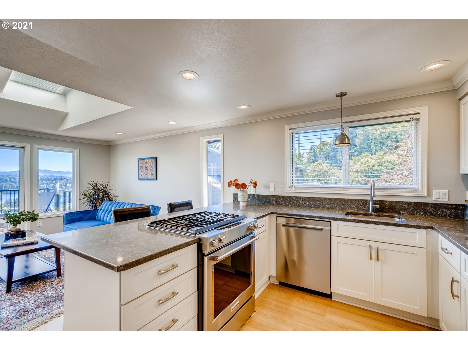 6530 Southwest View Point Terrace Portland, OR 97239 - Photo 9 of 32 a kitchen that has a sink a stove counter top space and a window in it