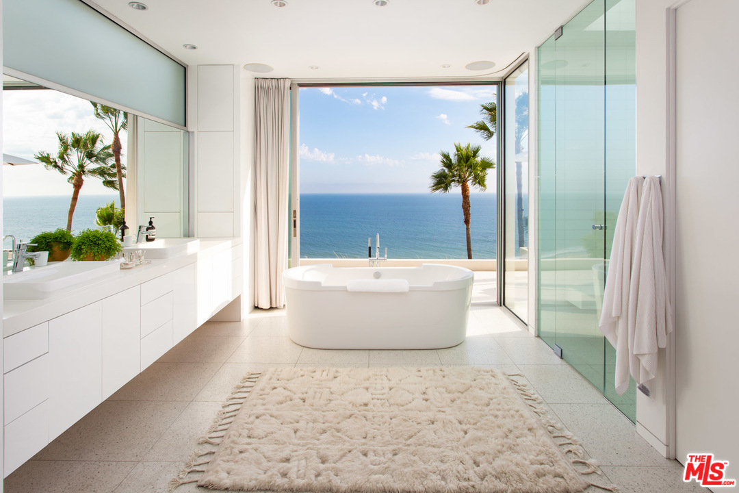 213 Pintoresca Drive Pacific Palisades, CA 90272 - Photo 11 of 23 a white bath tub sitting in a bathroom next to a window