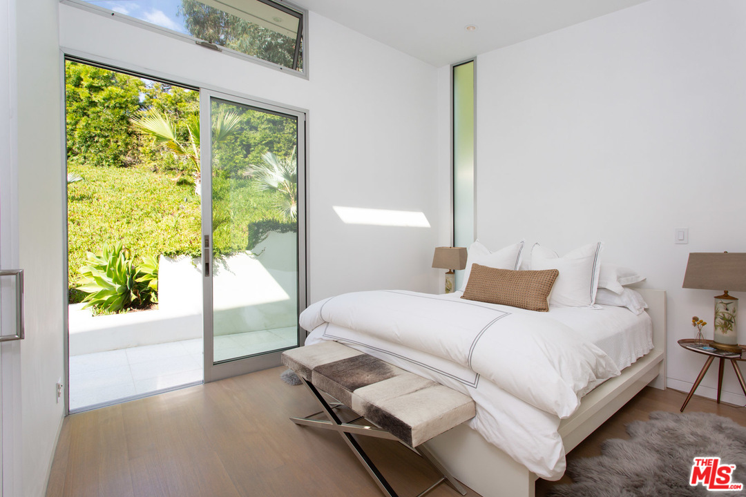 213 Pintoresca Drive Pacific Palisades, CA 90272 - Photo 13 of 23 a bedroom with a bed and a large window
