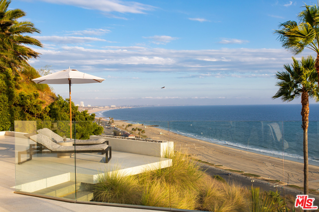 213 Pintoresca Drive Pacific Palisades, CA 90272 - Photo 15 of 23 a view of a swimming pool with an outdoor seating