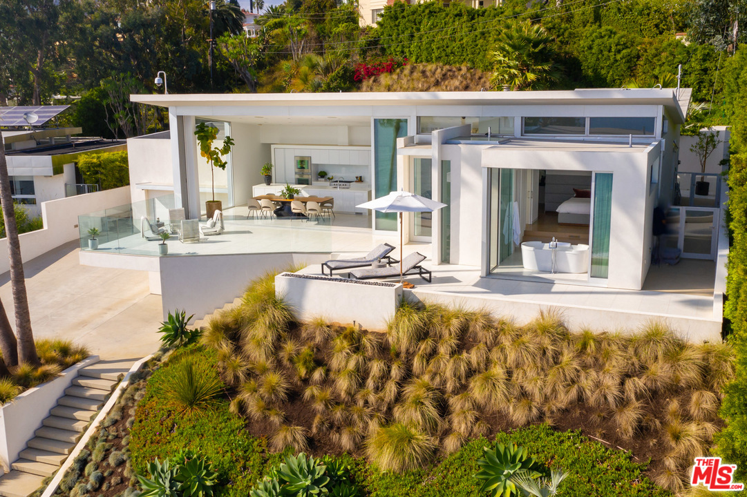 213 Pintoresca Drive Pacific Palisades, CA 90272 - Photo 3 of 23 a view of a swimming pool with outdoor seating