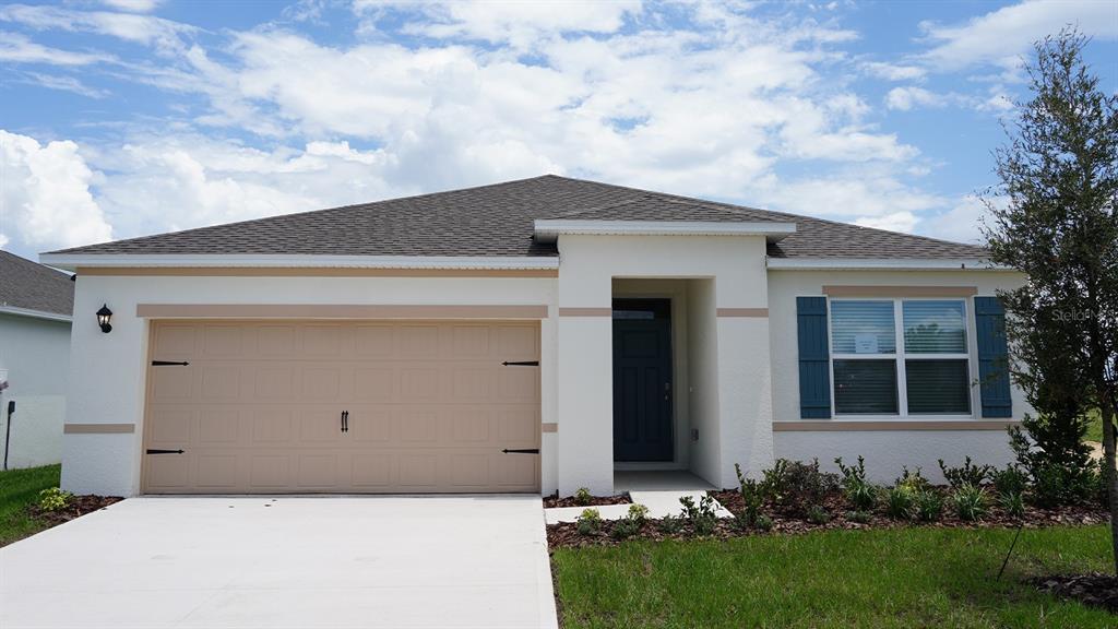 5131 Orchard Oriole Loop Bartow, FL 33830 - Photo 1 of 17 a front view of a house with a garden