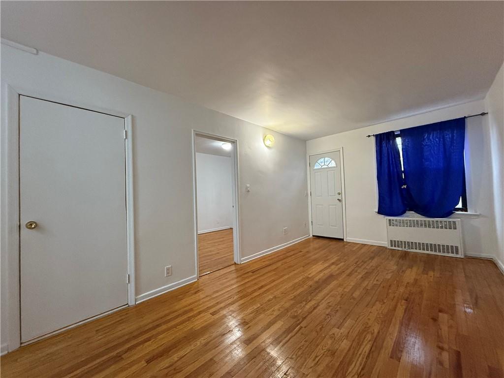 2373 Bragg Street Brooklyn, NY 11229 - Photo 11 of 11 a view of an empty room with wooden floor and cabinet