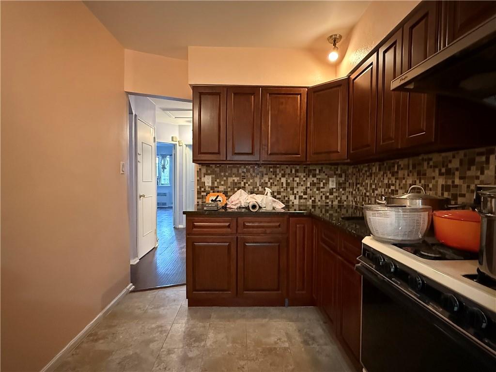 2373 Bragg Street Brooklyn, NY 11229 - Photo 5 of 11 a kitchen with stainless steel appliances granite countertop a refrigerator and a stove top oven