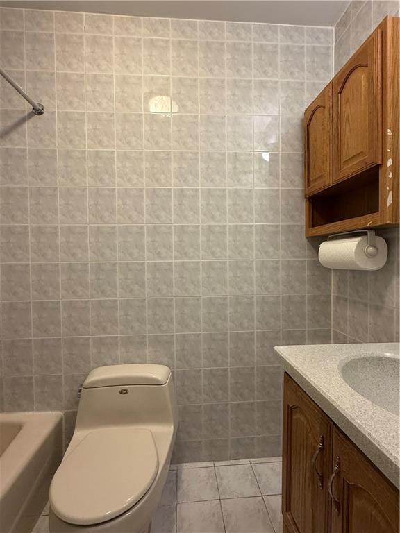 2373 Bragg Street Brooklyn, NY 11229 - Photo 6 of 11 a bathroom with a toilet a sink and mirror