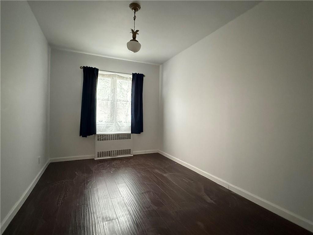 2373 Bragg Street Brooklyn, NY 11229 - Photo 7 of 11 an empty room with wooden floor and windows