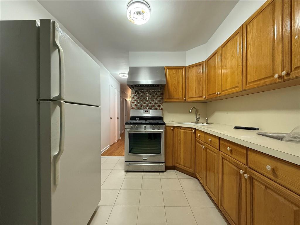 2373 Bragg Street Brooklyn, NY 11229 - Photo 8 of 11 a kitchen with a refrigerator sink and cabinets