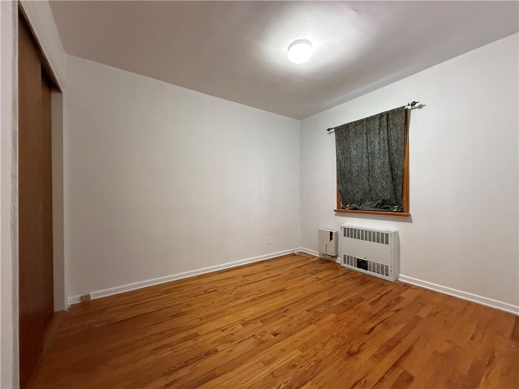 2373 Bragg Street Brooklyn, NY 11229 - Photo 10 of 11 a bedroom with a bed and a window