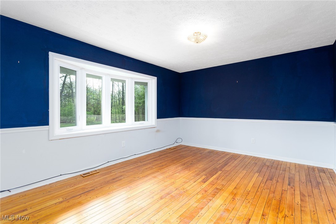 14566 West Ridge Road Novelty, OH 44072 - Photo 14 of 49 Unfurnished room with visible vents and wood-type flooring