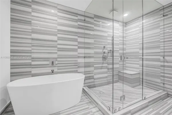 a bathroom with a bathtub and shower