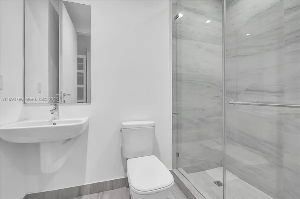 a bathroom with a sink toilet and shower