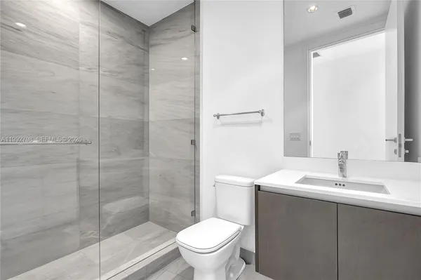 a bathroom with a sink toilet and shower