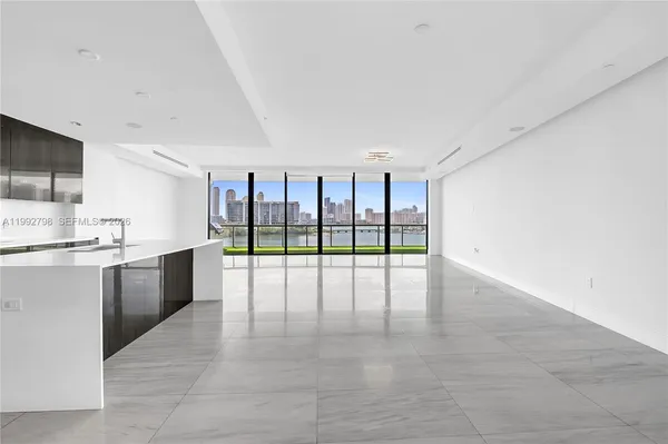 a large white kitchen with a large window