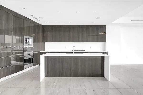 a kitchen with stainless steel appliances a cabinets and wooden floor
