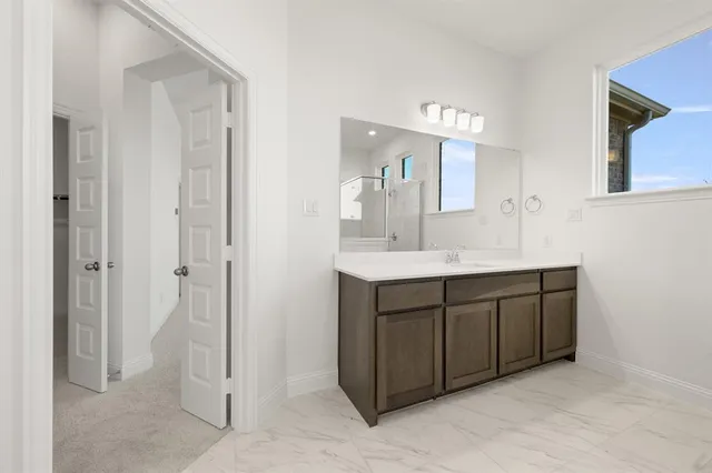 a bathroom with a double vanity sink mirror and