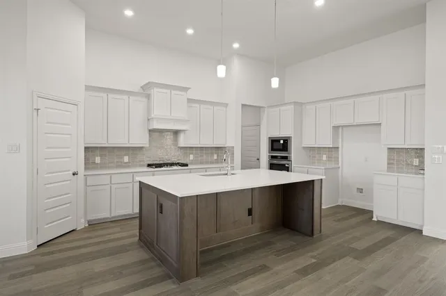 a kitchen with white cabinets and white appliances