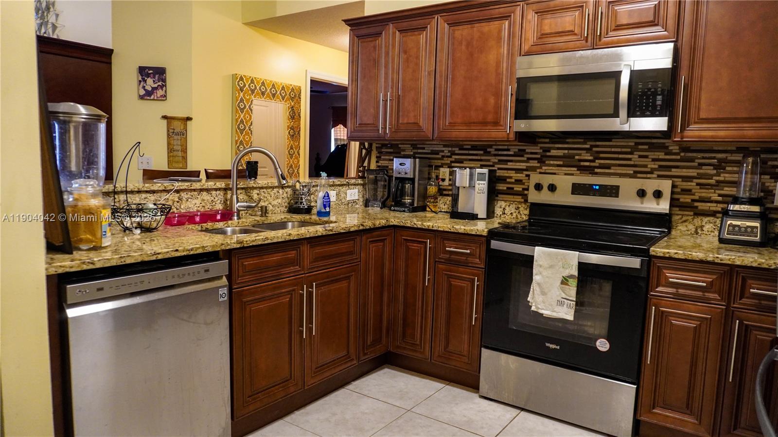1496 24th Avenue Southwest Vero Beach, FL 32962 - Photo 11 of 21 a kitchen with stainless steel appliances a stove a sink and a microwave