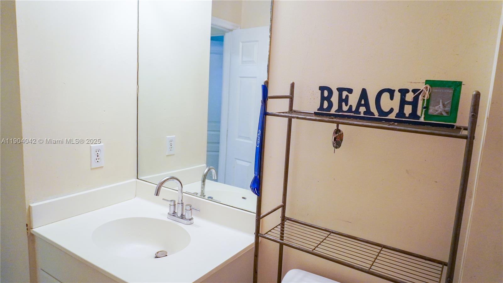 1496 24th Avenue Southwest Vero Beach, FL 32962 - Photo 16 of 21 a bathroom with a sink and a white door