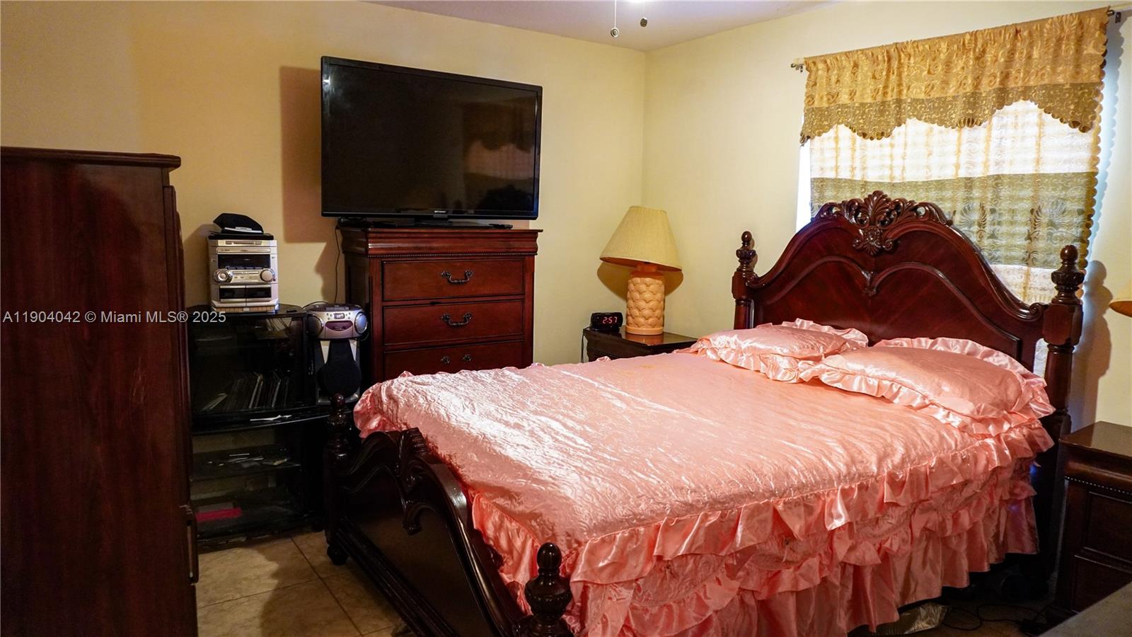 1496 24th Avenue Southwest Vero Beach, FL 32962 - Photo 18 of 21 a bedroom with a bed and a flat screen tv