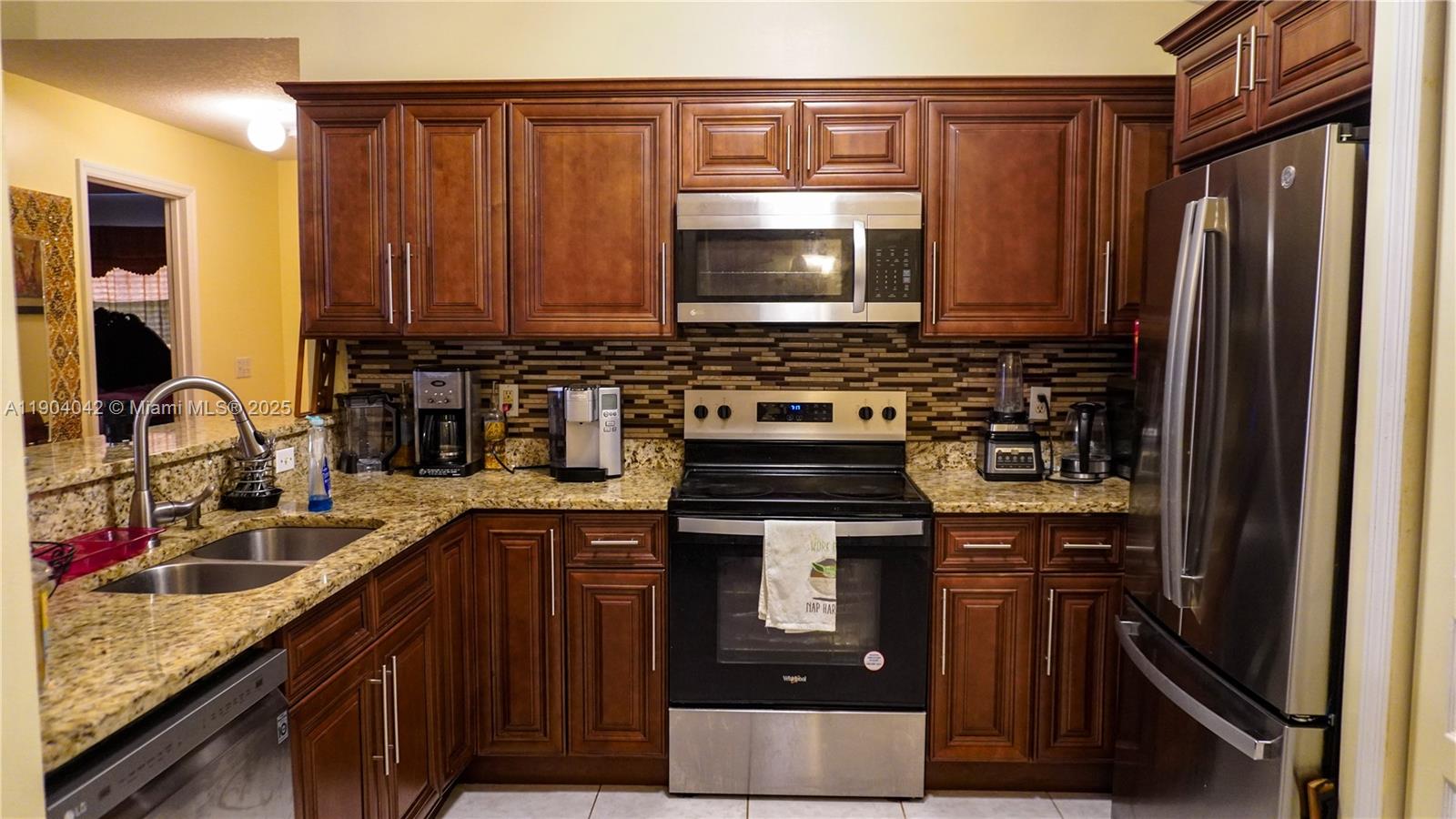 1496 24th Avenue Southwest Vero Beach, FL 32962 - Photo 10 of 21 a kitchen with a sink stove and microwave