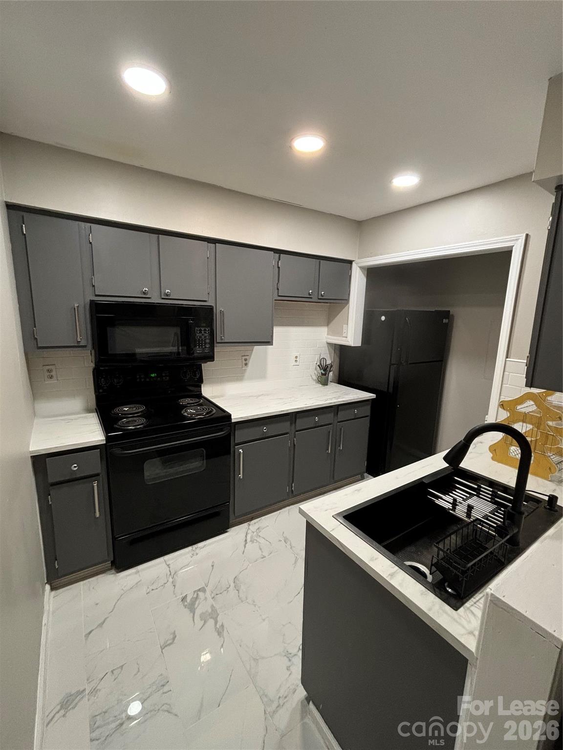 11040 Harrowfield Road Charlotte, NC 28226 - Photo 2 of 14 a kitchen with a stove and a refrigerator