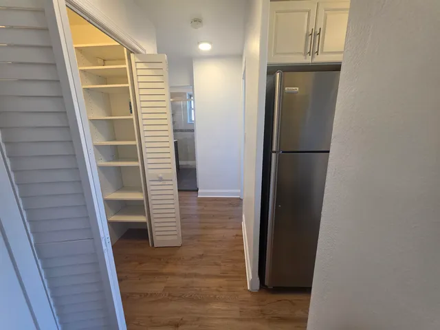 a view of walk in closet with empty racks