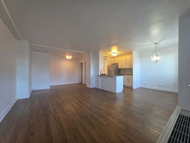 a view of a kitchen with a sink and dishwasher a kitchen view with wooden floor