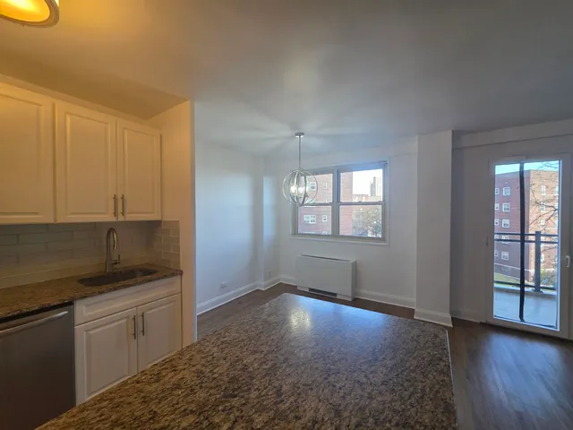 a kitchen with granite countertop a sink and cabinets