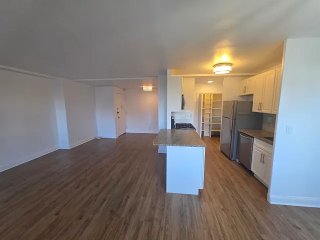 a view of kitchen and wooden floor