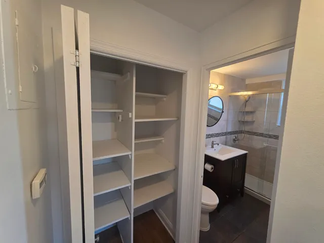 a bathroom with a toilet a sink and mirror