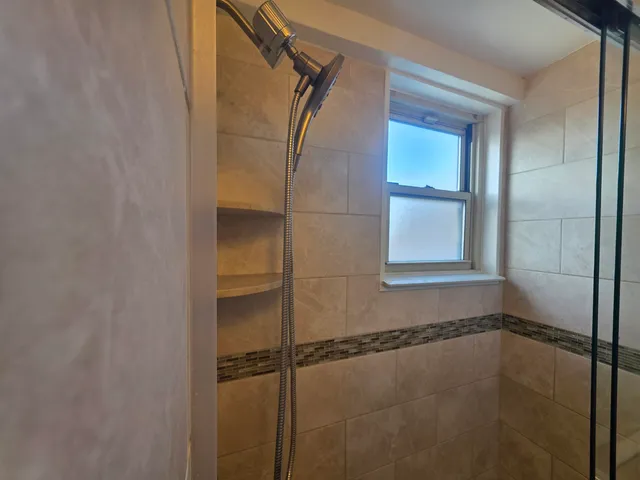 a bathroom with a glass shower door