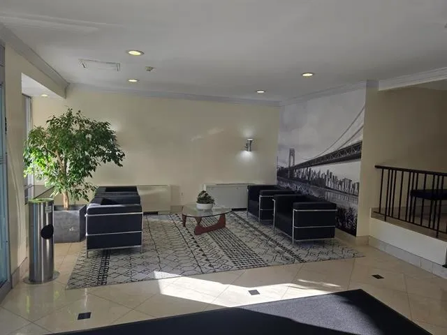 a living room with furniture and a piano