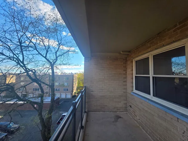 a view of hallway with wooden floor