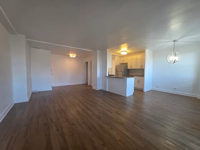 a view of a kitchen cabinets and wooden floor