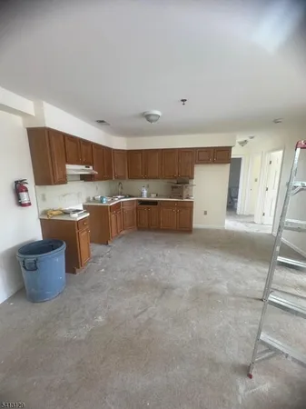 a kitchen with a sink and wooden cabinets