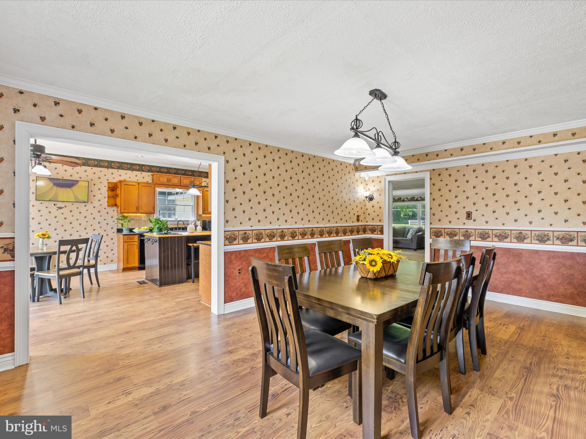28495 Fire Tower Road Laurel, DE 19956 - Photo 13 of 31 a view of a dining room and livingroom with furniture wooden floor a chandelier
