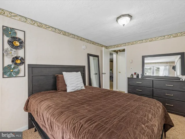 a bedroom with a bed and a dresser