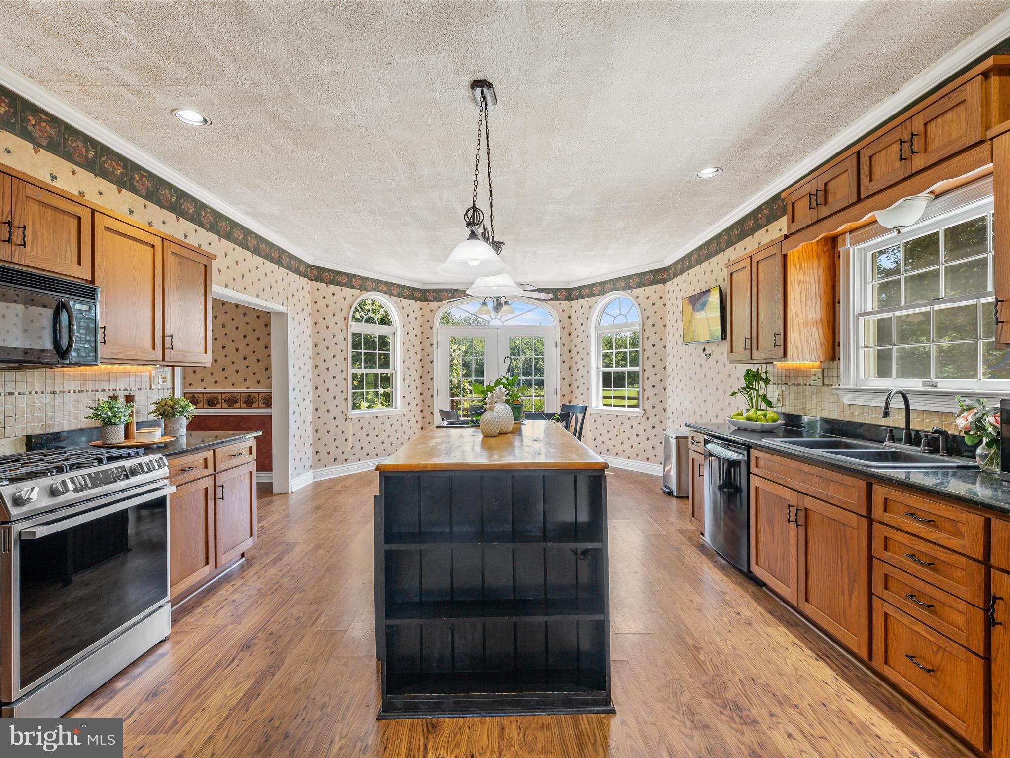 28495 Fire Tower Road Laurel, DE 19956 - Photo 7 of 31 a kitchen with stainless steel appliances granite countertop a stove and cabinets