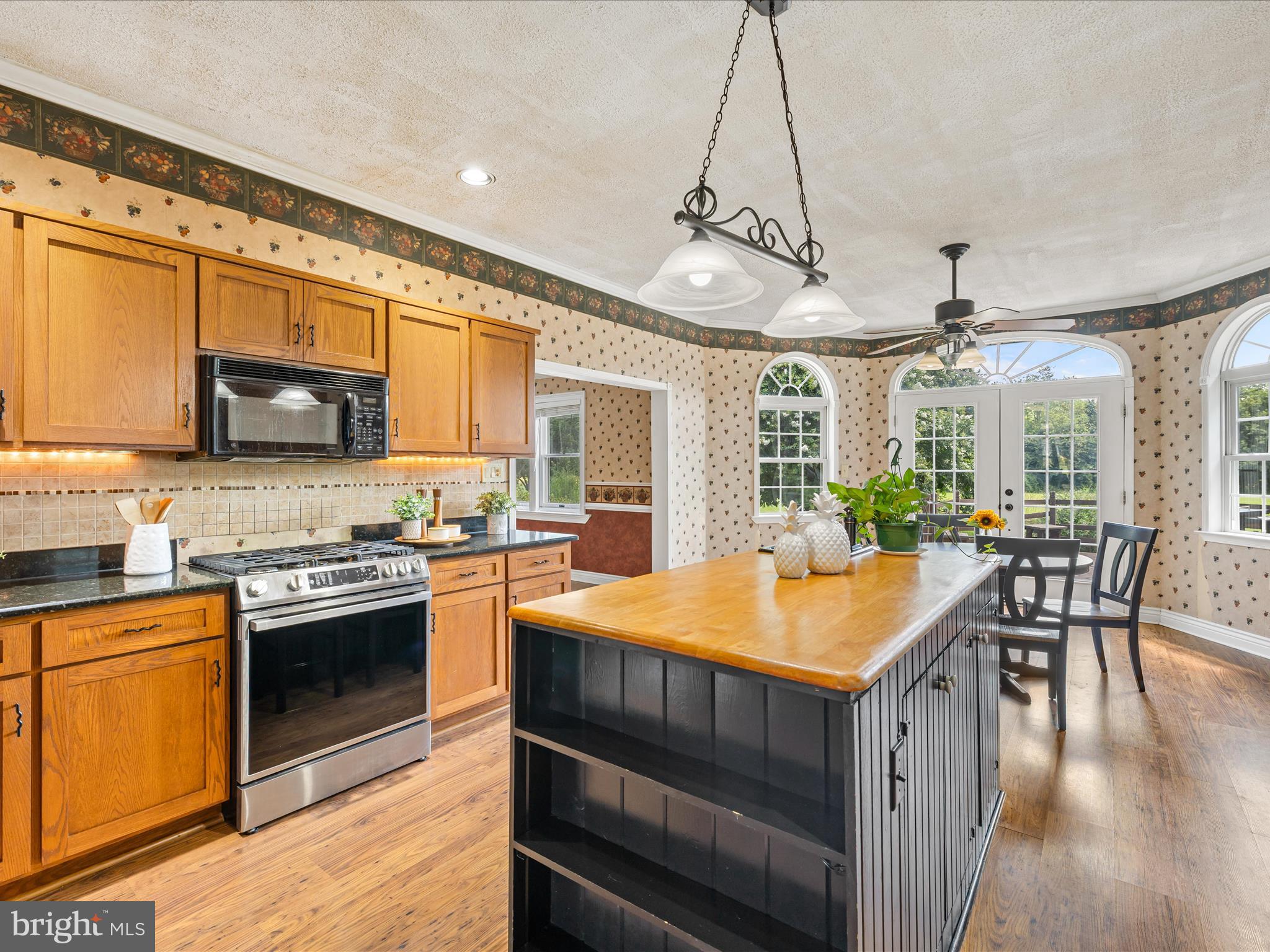 28495 Fire Tower Road Laurel, DE 19956 - Photo 8 of 31 a kitchen with stainless steel appliances granite countertop a stove and cabinets