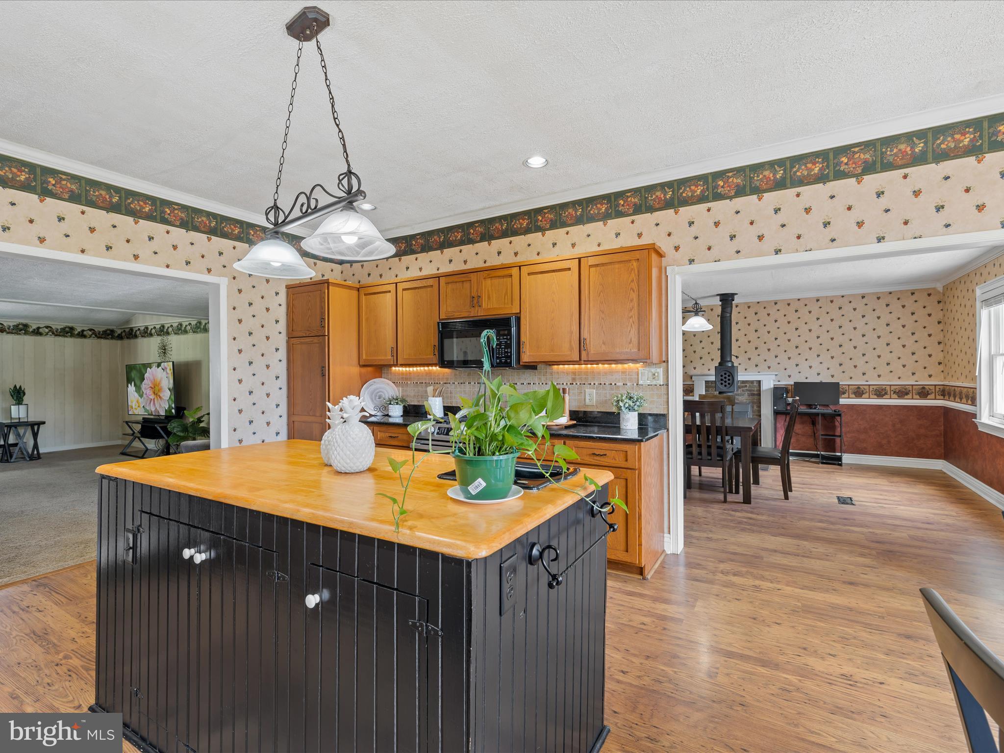 28495 Fire Tower Road Laurel, DE 19956 - Photo 10 of 31 a view of a dining room and livingroom with furniture wooden floor a chandelier