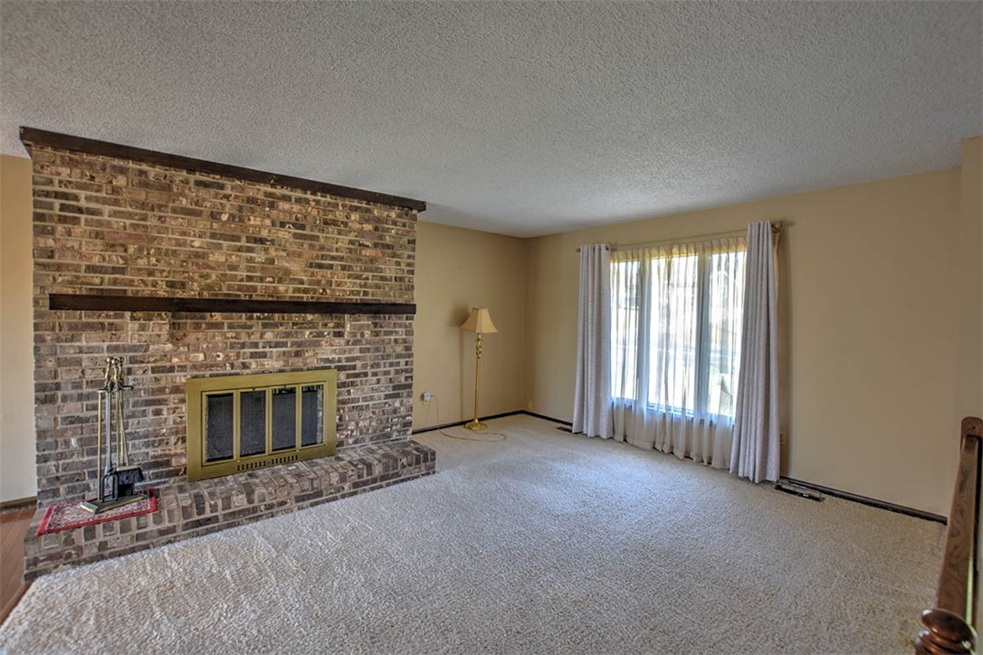 3441 Ferris Drive Decatur, IL 62521 - Photo 8 of 30 a view of an empty room with a fireplace and a window