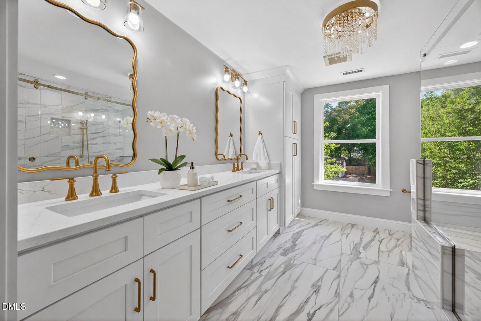 313 Crown Oaks Drive Raleigh, NC 27615 - Photo 17 of 60 a spacious bathroom with a double vanity sink and a large mirror